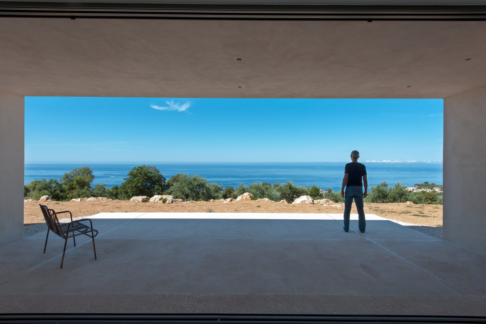 Figure standing in the panoramic opening facing the sea, Gonatsa house, Mani